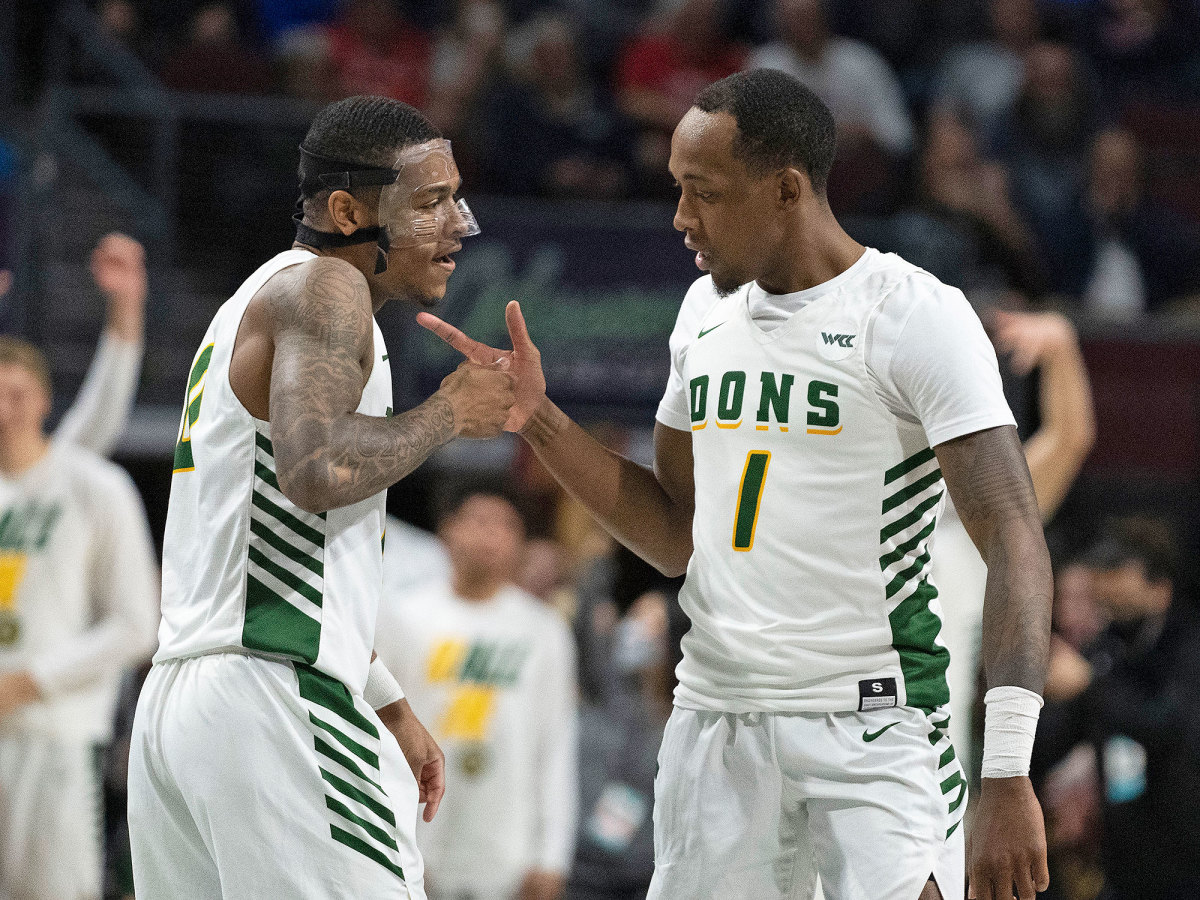 San Francisco’s Jamaree Bouyea (1) celebrates with guard Khalil Shabazz